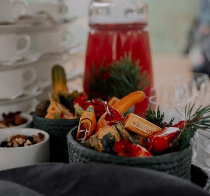 A beautifully arranged table with festive candies and glassware, perfect for a holiday gathering.
